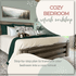 A neatly made bed with green and beige bedding and throw pillows, plus a dog lying on top; "Cozy Bedroom Refresh Workshop" by My Homier Home invites you to create your own cozy retreat.